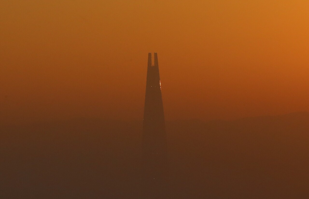 여명이 동틀무렵 남산에서 바라본 1일 오전 7시 47분께 지상 123층의 잠실 롯데월드타워의 실루엣 원경