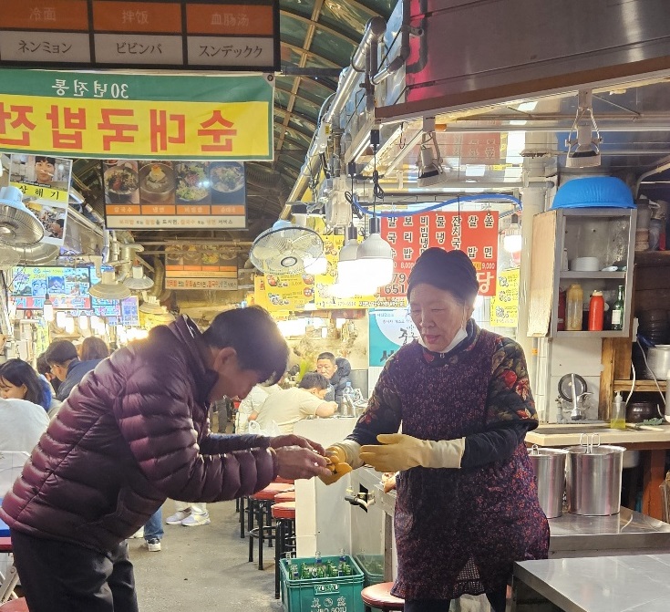 장영숙어르신이 오랜기간 보관하다 때마침 국밥집을 찾은 박승현 씨에게 선글라스를 되찾아 전달하고 있다./사진=박승현 전토달 회장